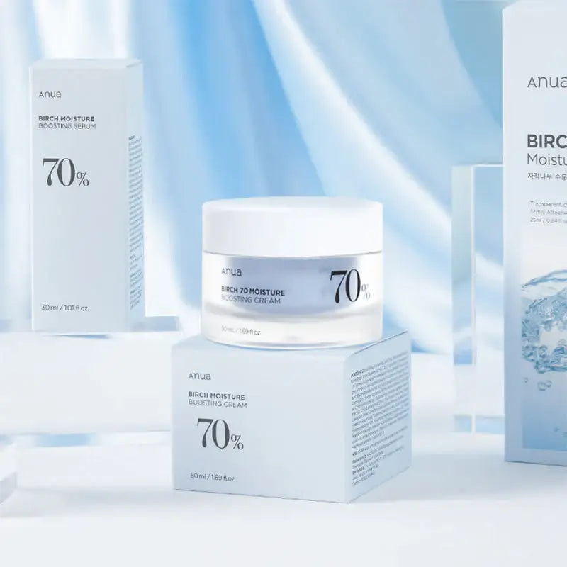 Anua Birch 70% Moisture Boosting Cream and Serum on a light blue background showcasing hydration benefits.