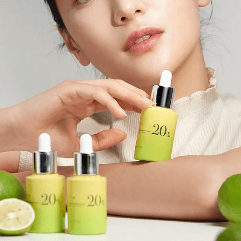 ANUA Green Lemon Vita C 20% Blemish Serum with model, lemon background highlighting brightening effects.