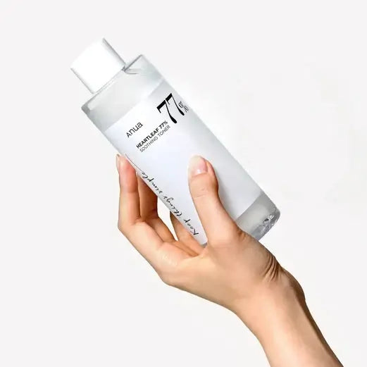 Anua Heartleaf 77% Soothing Toner in a hand, promoting hydration and balanced skin care.