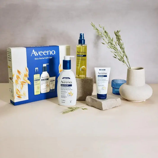 Aveeno Skin Relief Range 3 Piece Gift Set displayed with soothing skincare products and natural elements.
