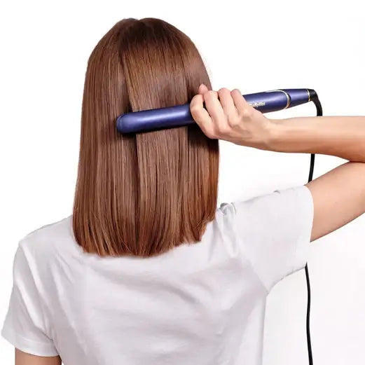 User using BaByliss Midnight Luxe 235 Straightener on straight hair for a sleek look.
