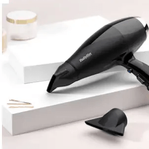 BaByliss Air Pro 2300 Dryer in black, styled on a minimalistic surface with beauty accessories.