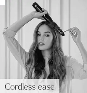Woman using BaByliss Cordless Curling Tong for effortless curls with cordless ease.