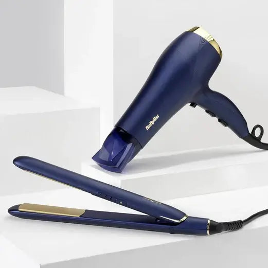 BaByliss Midnight Luxe 2300 Hairdryer and straightener in deep blue with gold accents on a minimalist background.