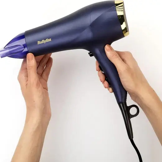 BaByliss Midnight Luxe 2300 Dryer held in hands, showcasing its sleek design and lightweight features.