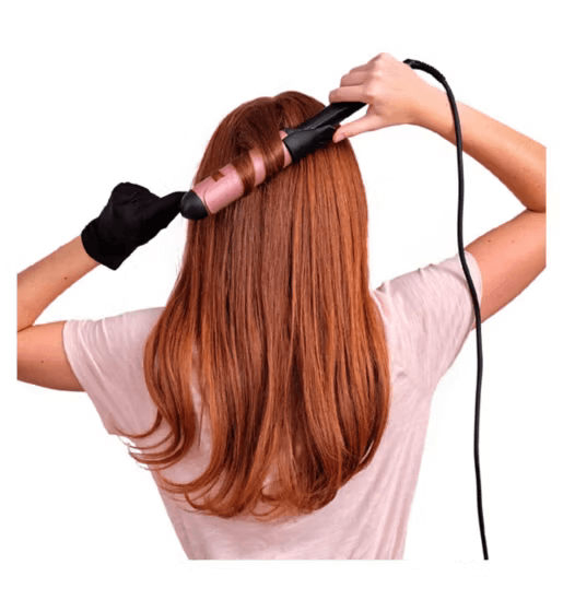 Woman styling long hair with BaByliss Rose Quartz 38mm curling tongue for soft, loose waves.