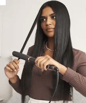 Woman using BaByliss Smooth Pro 235 Hair Straightener for sleek, frizz-free hair styling.