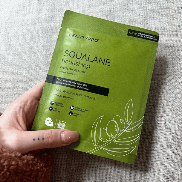 BeautyPro SQUALANE Nourishing Facial Sheet Mask held in hand, featuring natural ingredients for radiant skin.