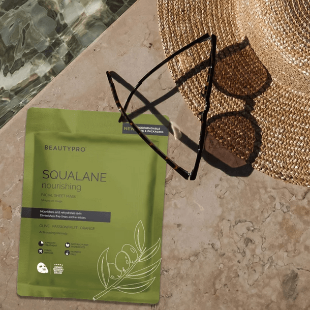 BeautyPro SQUALANE Nourishing Facial Sheet Mask on a sunlit surface with sunglasses, promoting radiant skin.