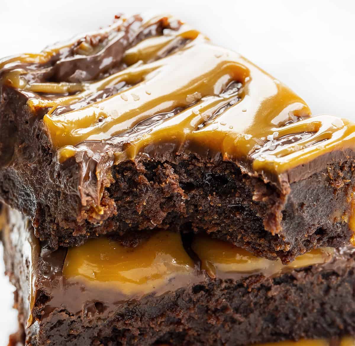 Gooey salted caramel brownie slice with rich chocolate and caramel drizzle on top.