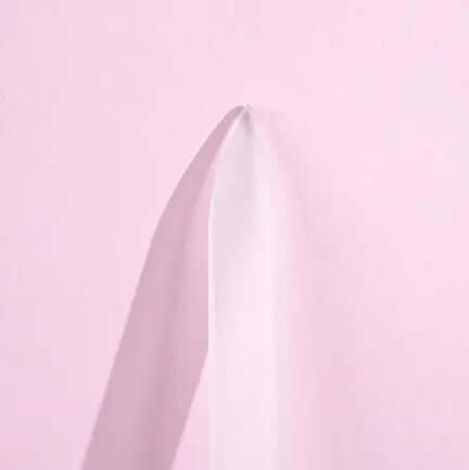 Brushworks Crystal Glass File on a pink background, showcasing its sleek, durable design for manicure perfection.