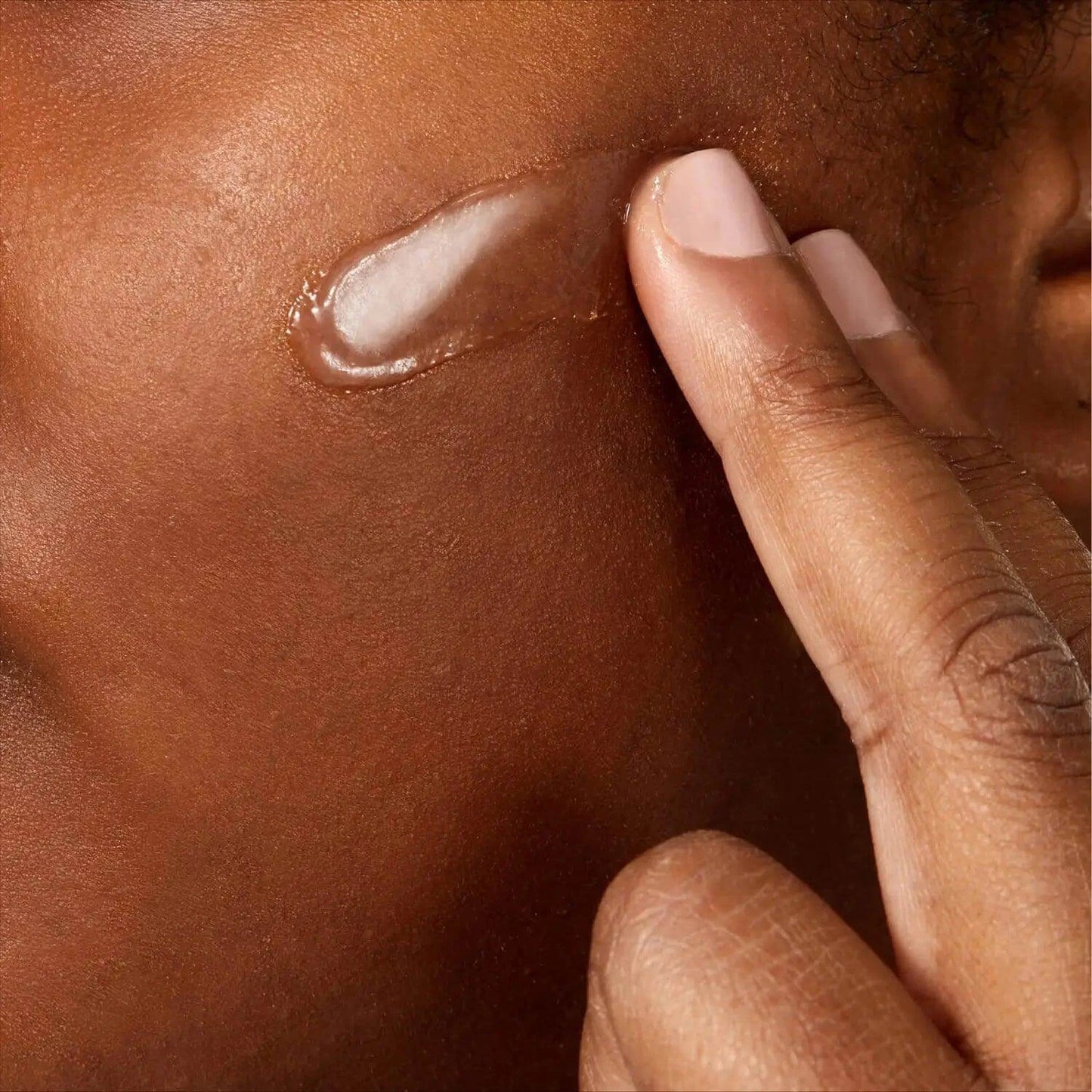Applying CeraVe Advanced Repair Ointment to hydrate dry skin on the face.