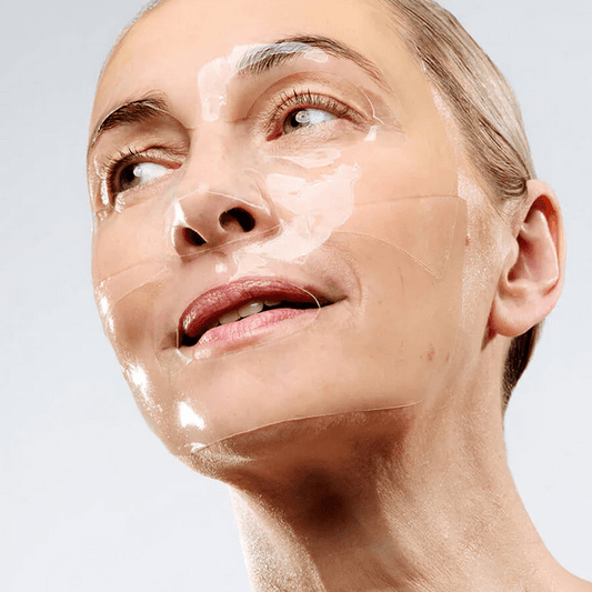 Woman using CurrentBody Skin Hydrogel Mask for radiant skin and hydration.