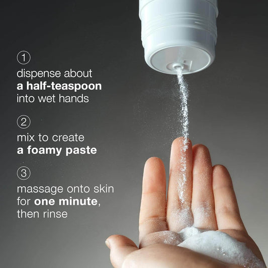 Hand using a white container to dispense a Dermalogica foamy paste onto wet hands with text instructions.
