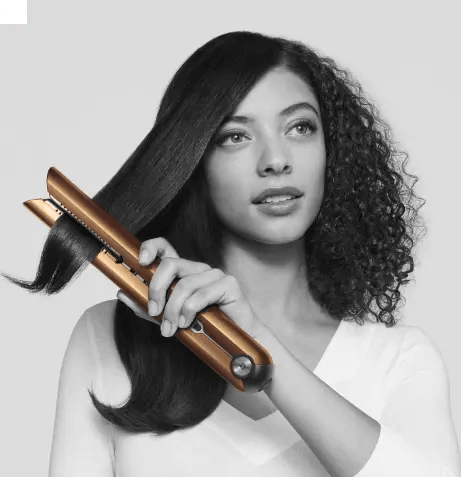 Dyson Corrale Straightener Copper/Nickel being used on hair for sleek styling and versatility.