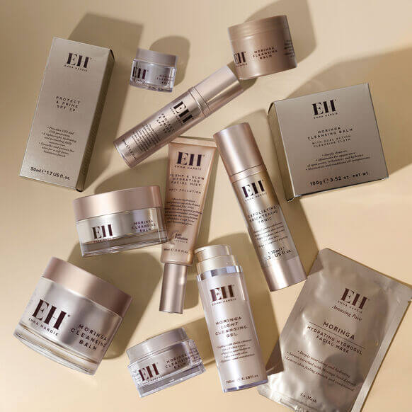 Collection of Emma Hardie skincare products on a beige background