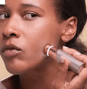 Woman using Finishing Touch Flawless™ Face 3.0 to remove unwanted hair for smooth, glowing skin.