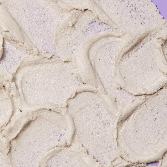Close-up of First Aid Beauty KP Bump Eraser Body Scrub showing creamy texture with exfoliating particles.