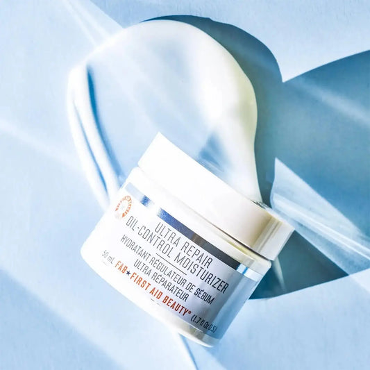 First Aid Beauty Oil-Control Moisturizer 50ml in jar with swirled cream on background; ideal for oily skin and keeping pores clear.