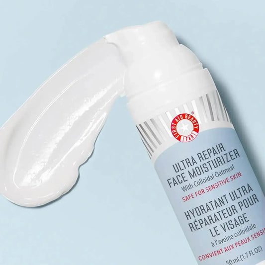 First Aid Beauty Ultra Repair Face Moisturizer 50ml with a creamy texture on a light background, hydrating dry skin.