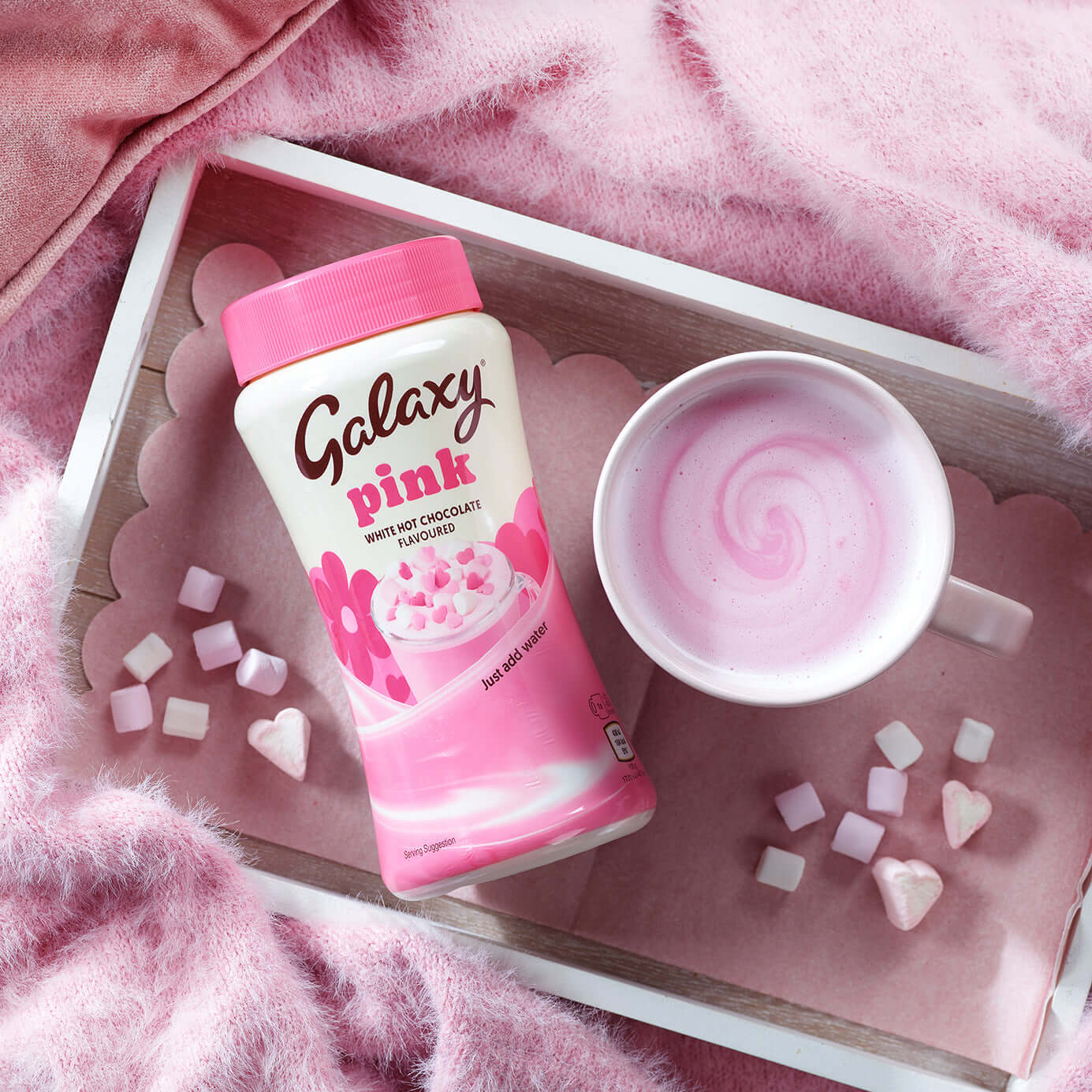 Galaxy Pink Hot Chocolate drink with pink marshmallows in a cozy setting, perfect for indulgence.