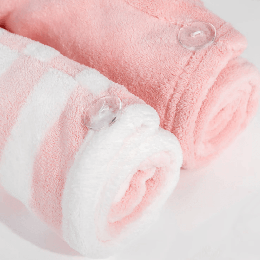 Brushworks Luxury Hair Towels (2 Pack) in pink and white, featuring soft materials and buttons for secure wrapping.