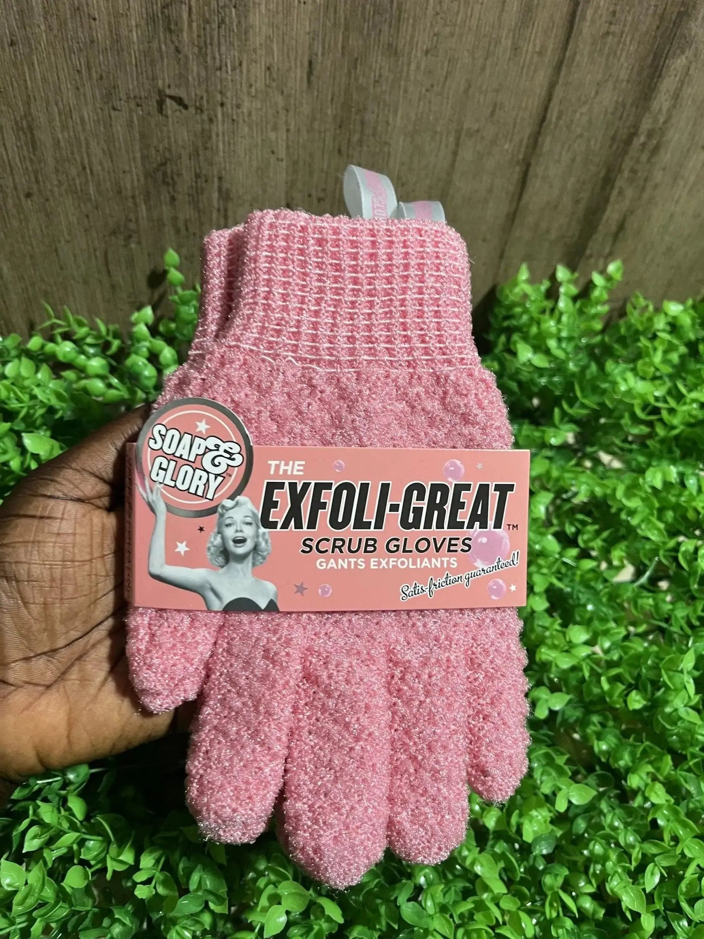 Soap & Glory Exfoliating Scrub Gloves, super-exfoliating for smooth skin, displayed on a green background.
