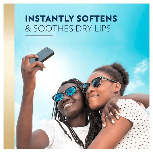 Vaseline Lips Moisturising Therapy Tin 20g, women enjoying soft lips while taking a selfie outdoors under blue sky.