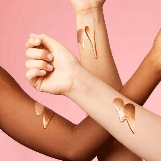 Different skin tones showcasing Sol de Janeiro GlowMotions Glow Body Oil with bronze shimmer on arms.