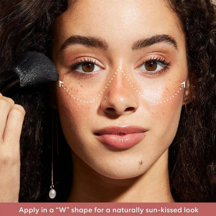 Model demonstrating application of bareMinerals Gen Nude Blonzer in a W shape for a sun-kissed glow.