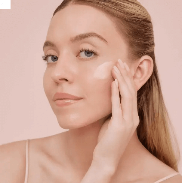 Woman applying LANEIGE Bouncy and Firm Sleeping Mask on her face for a radiant glow.