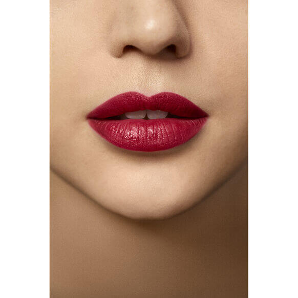 Close-up of lips wearing Laura Mercier Rouge Essentiel Silky Crème Lipstick in vibrant red shade.