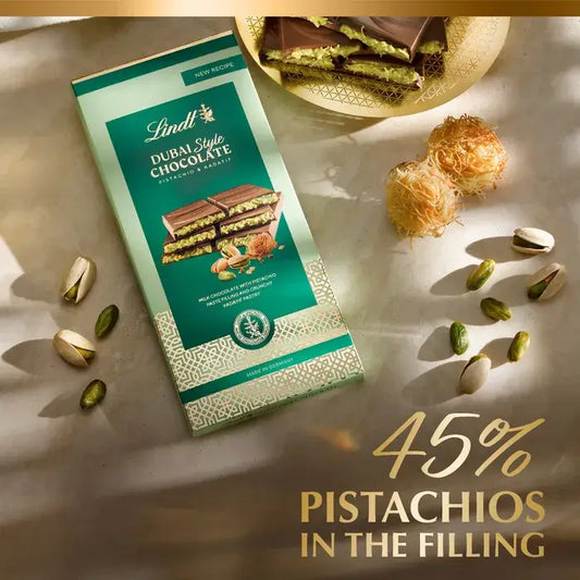 Lindt Dubai Style Chocolate Bar 145g with pistachios and aromatic fillings, elegantly displayed with pistachios and sweets.
