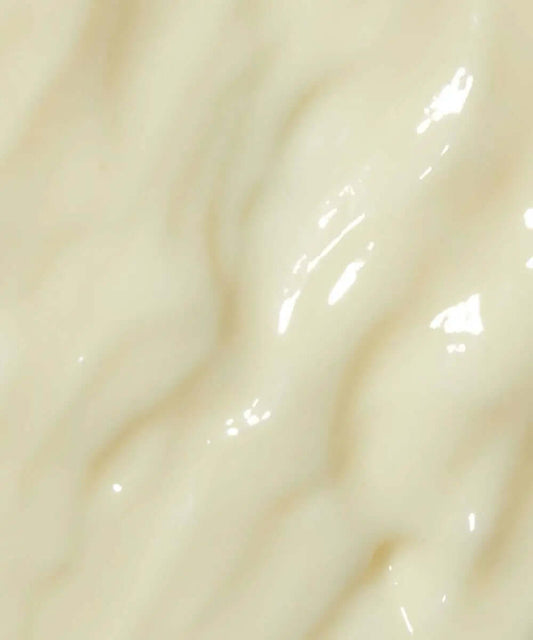 Close-up of MIELLE ORGANICS Rosemary Mint Daily Styling Crème, showcasing its creamy, smooth texture.