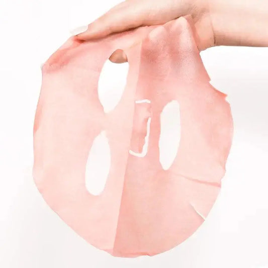 Hand holding Patchology Serve Chilled Rosé Sheet Mask showcasing its hydrating and luxurious pink design.