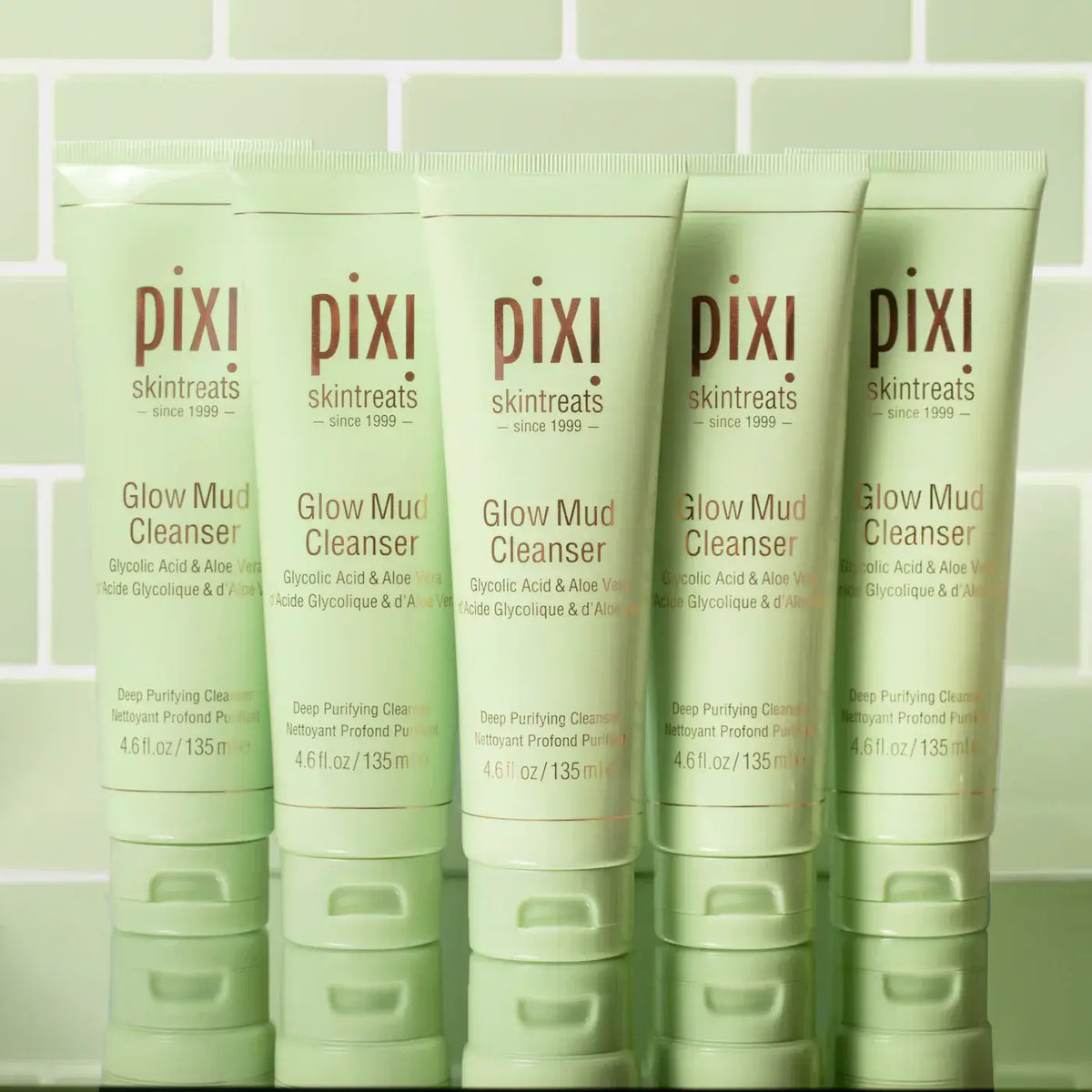 Five tubes of PIXI Glow Mud Cleanser 135ml, enriched with glycolic acid and aloe for radiant skin.