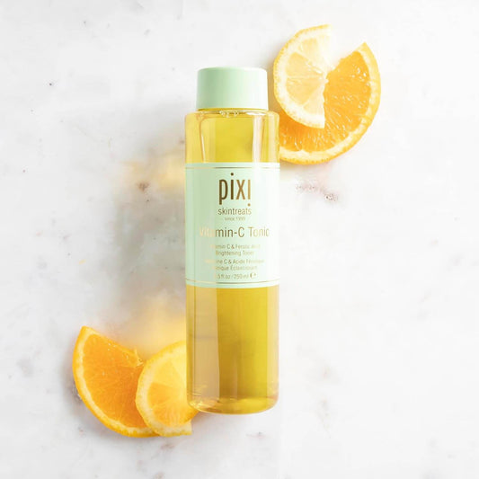 Pixi Vitamin C Tonic bottle with lemon slices on a light background