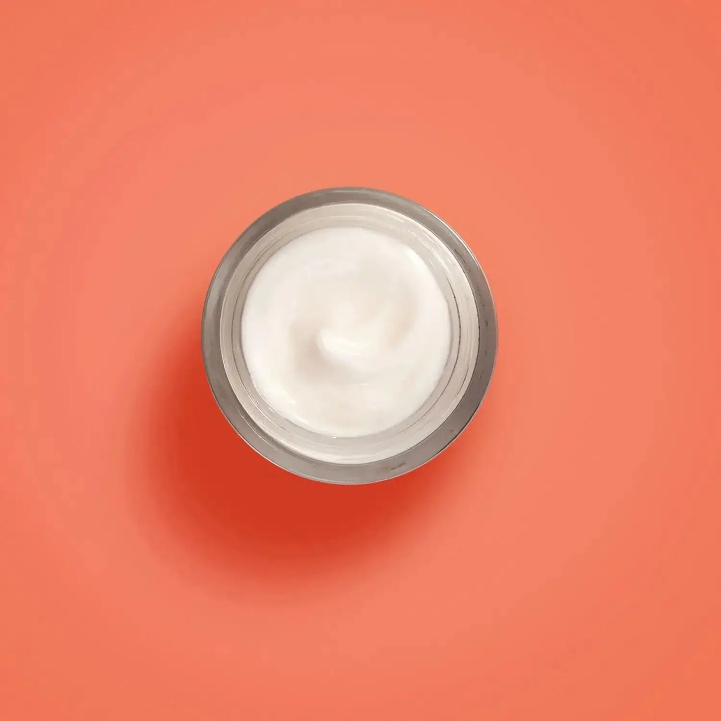 Collistar Vitamin C + Ferulic Acid Cream, luxurious moisturizer in a jar against an orange background.