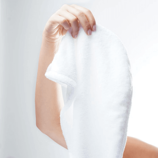 Person holding a Brushworks microfibre hair towel, showcasing its soft texture and absorbent material.