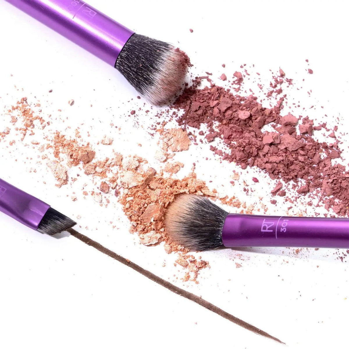 Real Techniques Eye Shade + Blend Brush Set with makeup powders and dual-ended brow brush on a white background.