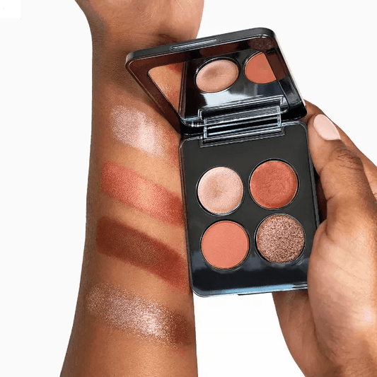 RÓEN Eyes On Me Eyeshadow Palette displayed with swatches of copper and rose gold shades on arm.