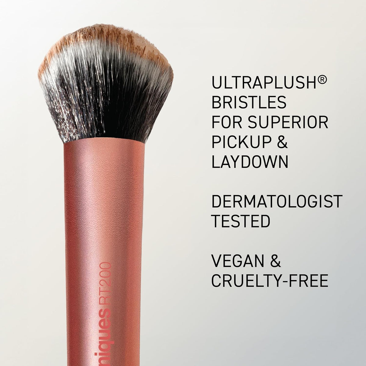 Makeup brush with text highlighting features on a light gray background