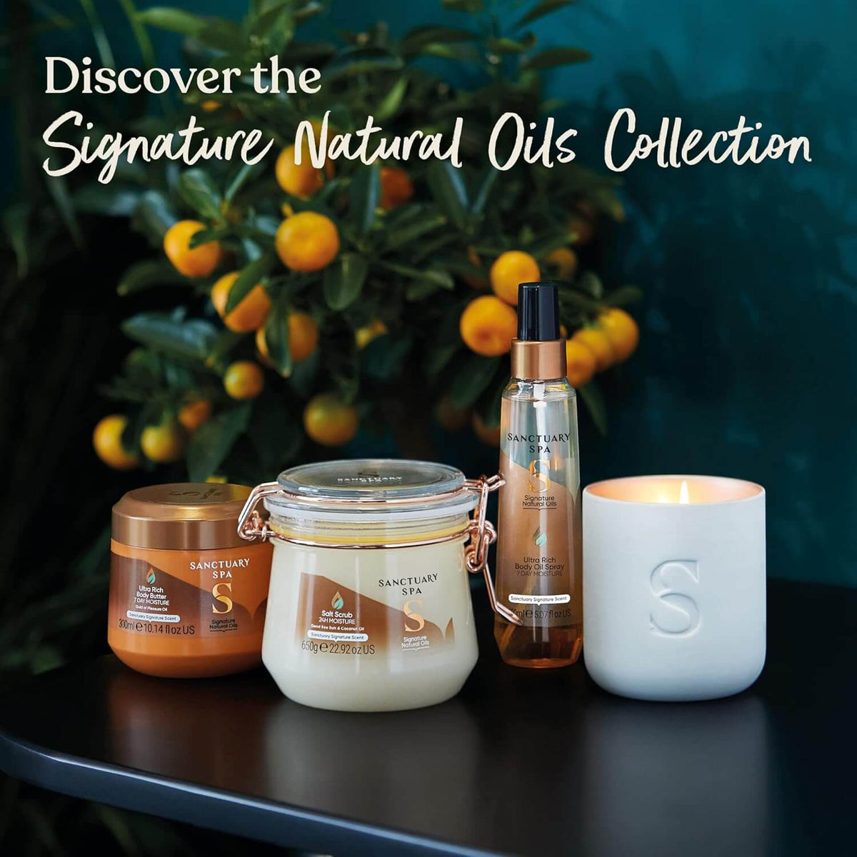 Sanctuary Spa products including a jar, bottle, and candle on a dark surface with a blurred background of oranges and greenery.