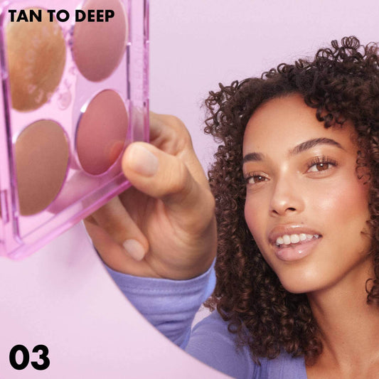 SEPHORA COLLECTION Colorful Face Palette in Tan to Deep held by a model with curly hair, showcasing warm makeup shades.