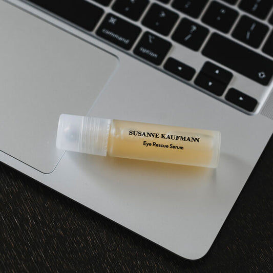 Susanne Kaufmann Eye Rescue Serum tube on a laptop keyboard