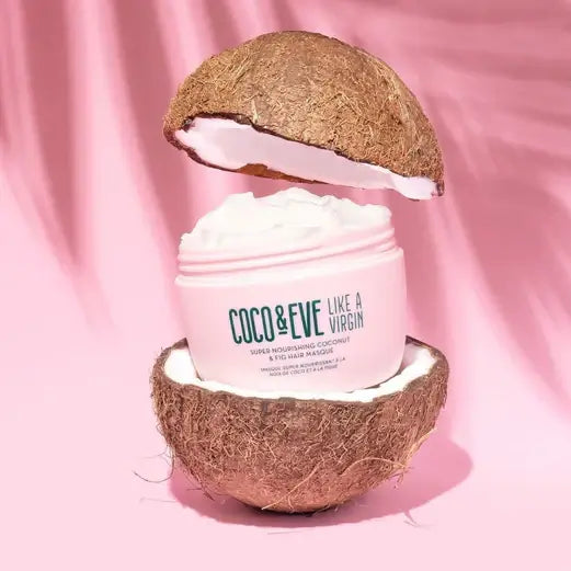 Coco & Eve Like a Virgin Coconut & Fig Hair Mask in a coconut shell, showcasing its nourishing cream formula.