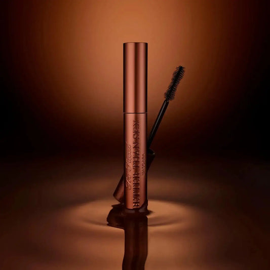 Too Faced Better Than Sex Mascara in Chocolate 8ml, featuring a sleek tube and brush, on a reflective dark background.