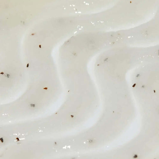 Close-up of Tree Hut Sugar Scrub Coco Colada, showcasing its creamy texture and exfoliating particles for smooth skin.