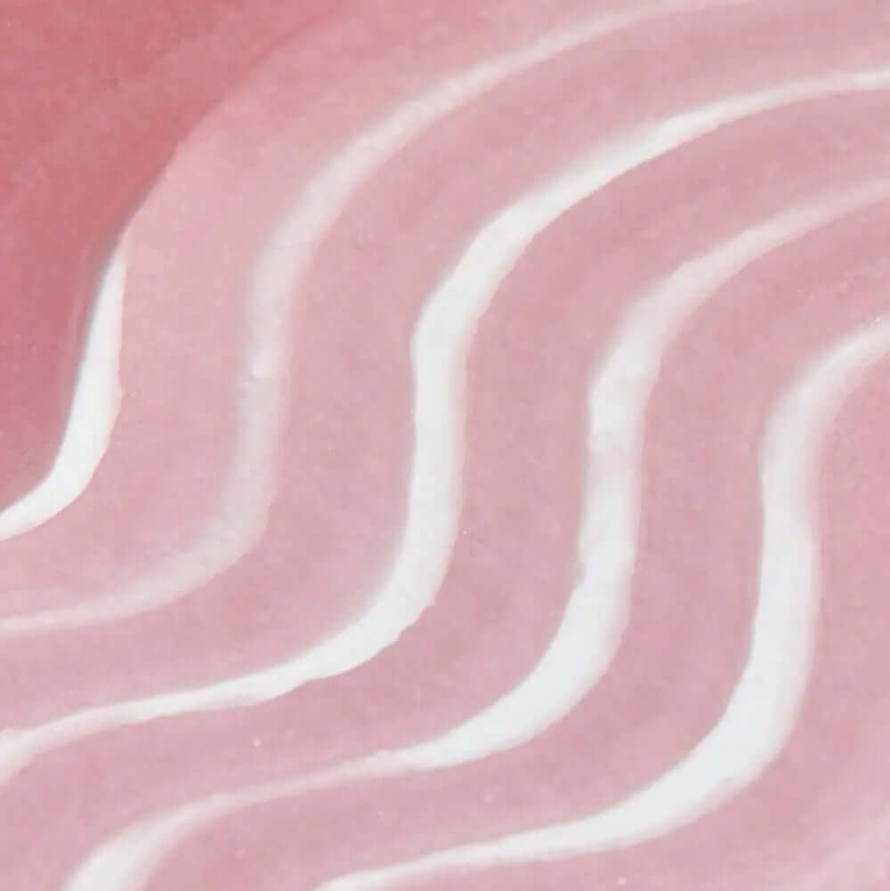 Close-up of a pink and white textured of Tree Hut Desert Haze Sugar Scrub , ideal for promoting skincare products.