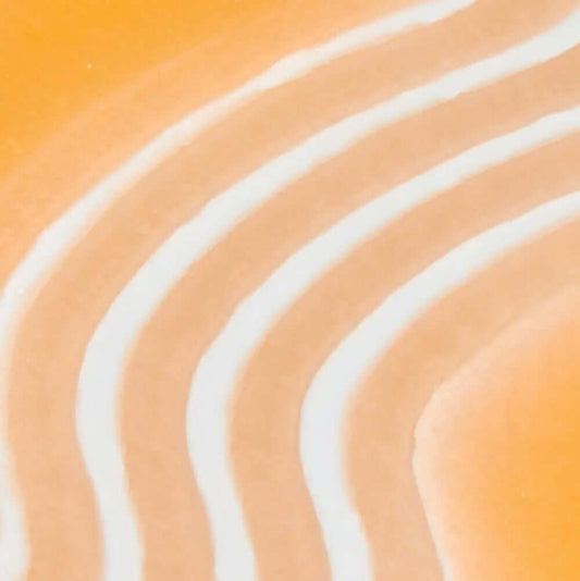 TREE HUT Sugar Scrub Papaya Paradise Close-up of swirled orange and white stripes, resembling the texture of a sugar scrub.